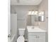 Updated bathroom featuring a white vanity, mirror, and shower-tub combination at 3130 Glen Knolls Ct, Alpharetta, GA 30022