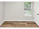 A bedroom with hardwood floors and a large window at 3130 Glen Knolls Ct, Alpharetta, GA 30022