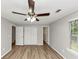 Neutral bedroom featuring wood-look floors, ample closet space, and bright natural lighting at 3130 Glen Knolls Ct, Alpharetta, GA 30022