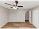 Well-lit bedroom with ceiling fan, wood-look flooring, and convenient access to closet and door at 3130 Glen Knolls Ct, Alpharetta, GA 30022