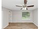 Bright bedroom with ceiling fan, wood-look floors, and natural light from the window at 3130 Glen Knolls Ct, Alpharetta, GA 30022