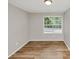 A bedroom with hardwood floors and a large window at 3130 Glen Knolls Ct, Alpharetta, GA 30022