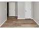 A bedroom with hardwood floors, gray walls, and two closets at 3130 Glen Knolls Ct, Alpharetta, GA 30022