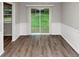 Bright dining room with a sliding door to the backyard and updated floors at 3130 Glen Knolls Ct, Alpharetta, GA 30022