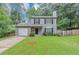 Charming two-story home featuring a manicured lawn and a convenient one-car garage at 3130 Glen Knolls Ct, Alpharetta, GA 30022