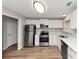 A modern kitchen with stainless steel appliances, white cabinetry, and hardwood floors at 3130 Glen Knolls Ct, Alpharetta, GA 30022
