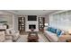 Staged living room showcasing a fireplace with built-in bookshelves and comfortable seating at 3130 Glen Knolls Ct, Alpharetta, GA 30022
