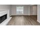 Spacious living room with a fireplace and updated flooring, offering a cozy ambiance at 3130 Glen Knolls Ct, Alpharetta, GA 30022