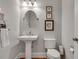 Half bathroom with pedestal sink, an oval mirror, and classic fixtures at 345 Glen Iris Ne Dr # 3, Atlanta, GA 30312