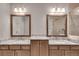 Dual sink bathroom vanity with granite counters, wood cabinets, and large mirrors at 345 Glen Iris Ne Dr # 3, Atlanta, GA 30312