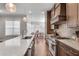 Bright kitchen featuring stone countertops, tiled backsplash, stainless appliances and hanging globe lights at 345 Glen Iris Ne Dr # 3, Atlanta, GA 30312
