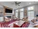 Bright living room with stone fireplace, built-in shelves, ceiling fan, and a stylish rug at 345 Glen Iris Ne Dr # 3, Atlanta, GA 30312