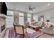 Open living room with large windows, stone fireplace, ceiling fan, and comfortable seating at 345 Glen Iris Ne Dr # 3, Atlanta, GA 30312