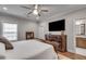 Spacious main bedroom with hardwood floors, TV, and attached bath at 345 Glen Iris Ne Dr # 3, Atlanta, GA 30312