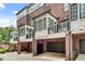 Townhome rear exterior featuring attached garages and Juliet balconies at 345 Glen Iris Ne Dr # 3, Atlanta, GA 30312