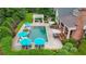 Aerial view of a backyard featuring a sparkling pool, pergola, patio, and lush landscaping at 710 Cox Rd, Roswell, GA 30075