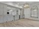 Home bar featuring custom cabinetry, granite counters, wine fridge, and designer lighting at 710 Cox Rd, Roswell, GA 30075