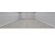 Clean, empty basement with neutral paint, white trim, and a white door at 710 Cox Rd, Roswell, GA 30075