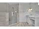 Modern bathroom with a frameless glass shower and a vanity with marble countertops at 710 Cox Rd, Roswell, GA 30075