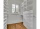 Custom closet with wood floor, adjustable shelves, drawers, and ample storage space at 710 Cox Rd, Roswell, GA 30075