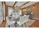 Bright dining space with brick accents, stylish chandelier, and natural light at 710 Cox Rd, Roswell, GA 30075