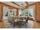 Elegant dining room with brick walls, hardwood floors, and natural light, perfect for entertaining guests at 710 Cox Rd, Roswell, GA 30075