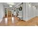 Elegant foyer with hardwood floors, a decorative light fixture, and a view of the staircase at 710 Cox Rd, Roswell, GA 30075