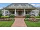Inviting front porch with comfortable seating, ceiling fans, and a brick pathway leading to the entrance at 710 Cox Rd, Roswell, GA 30075