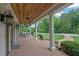 Spacious front porch featuring brick flooring, ceiling fans, and an outdoor seating area at 710 Cox Rd, Roswell, GA 30075