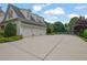 Home with a large driveway leading to a three car garage at 710 Cox Rd, Roswell, GA 30075