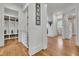 Bright hallway featuring wood floors, closet space, and white trim throughout at 710 Cox Rd, Roswell, GA 30075