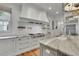Modern kitchen featuring white cabinetry, granite countertops, and stainless steel appliances at 710 Cox Rd, Roswell, GA 30075