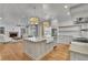 Well-appointed kitchen with an island, farm sink, and a seamless flow into the living area at 710 Cox Rd, Roswell, GA 30075