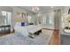 Luxurious main bedroom featuring a tufted headboard, natural light and designer touches at 710 Cox Rd, Roswell, GA 30075