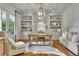 Bright home office with built-in shelves, a comfortable seating area, and natural light at 710 Cox Rd, Roswell, GA 30075