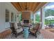 Covered patio featuring brick fireplace, stylish furniture, and open views at 710 Cox Rd, Roswell, GA 30075