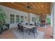 Outdoor patio with wood ceiling, brick fireplace, and dining and seating arrangements at 710 Cox Rd, Roswell, GA 30075