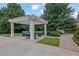 Cozy backyard pergola featuring comfortable seating and serene views of the surrounding landscape at 710 Cox Rd, Roswell, GA 30075