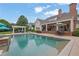Beautiful backyard with swimming pool, lounge area, and well-manicured landscaping at 710 Cox Rd, Roswell, GA 30075