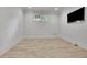 Bright room featuring vinyl plank flooring, baseboard trim, and large television at 710 Cox Rd, Roswell, GA 30075