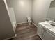 Bathroom with modern flooring, toilet, sink with cabinet, and shower at 8 Hazel St, Porterdale, GA 30014