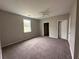 Spacious bedroom with neutral walls and carpet, ceiling fan and natural light from window at 8 Hazel St, Porterdale, GA 30014
