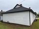 Classic white house featuring a black roof and well-maintained siding, exuding timeless charm at 8 Hazel St, Porterdale, GA 30014