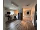 Modern kitchen with stainless appliances and newly installed laminate wood flooring at 8 Hazel St, Porterdale, GA 30014