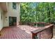 Wooden back deck overlooks a lush, wooded backyard providing a peaceful outdoor retreat at 8255 Habersham Waters Rd, Atlanta, GA 30350
