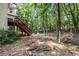 The sprawling backyard features a deck with stairs down to a partially wooded landscape at 8255 Habersham Waters Rd, Atlanta, GA 30350