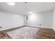 Spacious basement featuring wood-look floors and area rug at 8255 Habersham Waters Rd, Atlanta, GA 30350