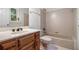 Bathroom featuring a combination shower and tub, tiled walls, and classic fixtures at 8255 Habersham Waters Rd, Atlanta, GA 30350