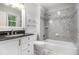 Beautiful bathroom featuring white cabinets, granite countertop, and shower over tub with gray tile surround at 8255 Habersham Waters Rd, Atlanta, GA 30350