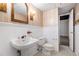 Cozy bathroom features a pedestal sink, classic fixtures, and vintage-inspired wallpaper at 8255 Habersham Waters Rd, Atlanta, GA 30350
